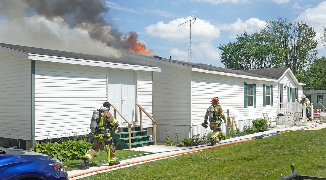 Firefighters arrive on the scene of Saturday afternoon's fire on T3 Lane, off of CR 675E. Photo by Gary Nieter, Times-Union