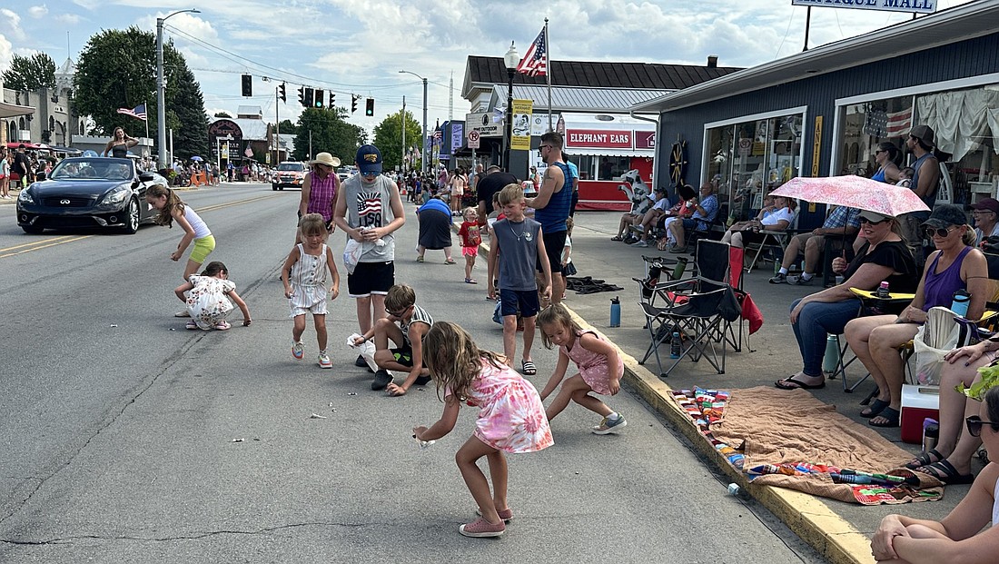 A number of kids take advantage of the free candy being thrown during the 78th annual North Webster Mermaid Festival parade Saturday afternoon. Photo by David Slone, Times-Union