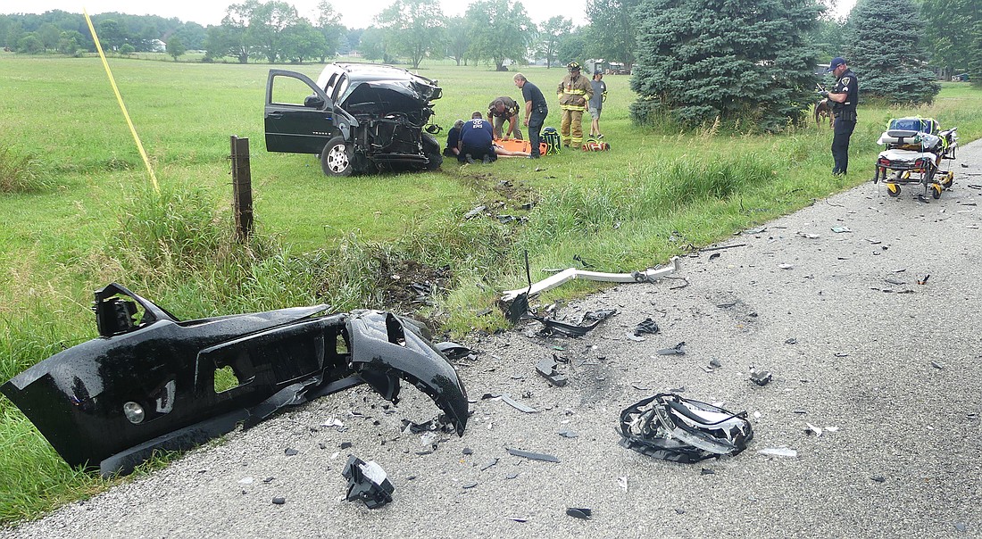 Emergency personnel tend to one of the victims involved in Saturday evening's two-vehicle accident on CR 150W, south of CR 400N. Photo by Gary Nieter, Times-Union.