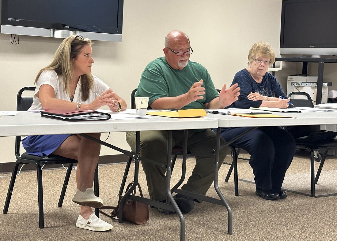 Kosciusko County Council President Mike Long (C) makes a statement during Wednesday’s council informational meeting, while Council Vice President Kathy Groninger (L) and Councilwoman Sue Ann Mitchell listen. Photo by David Slone, Times-Union