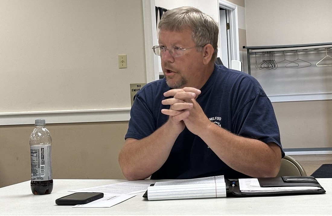 Milford Fire Chief Brian Haines asks the town council to send comments supporting the fire department at Monday’s meeting. Photo by Denise Fedorow