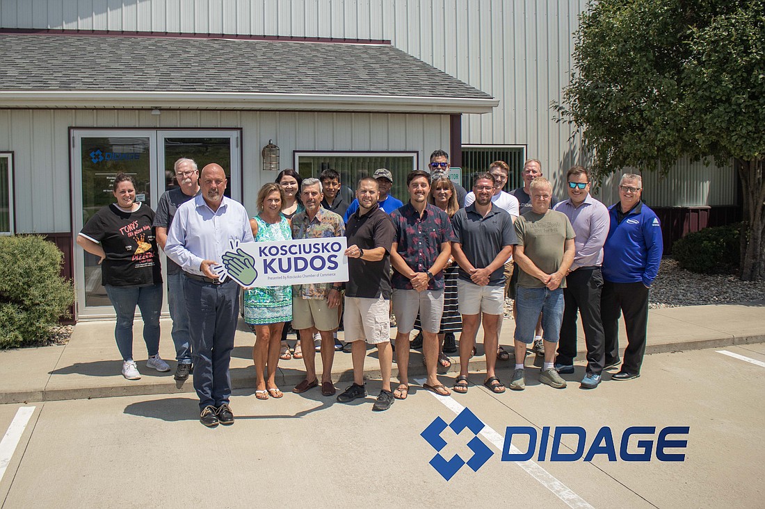 Associates of Didage Sales Company, Elkhart Community Schools and the Kosciusko County Chamber Of Commerce gather in front of the Didage Sales building in Warsaw.