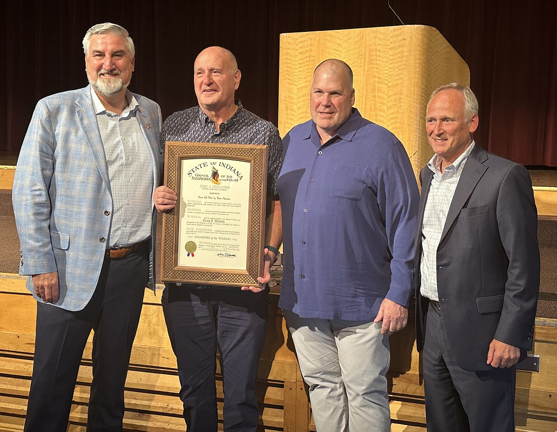 Indiana Gov. Eric Holcomb surprised Winona Lake Town Manager Craig Allebach with the Sagamore of the Wabash Thursday. Pictured (L to R) are Holcomb, Allebach, Winona Lake Town Council President Jim Lancaster and Indiana state Rep. Craig Snow. Photo by David Slone, Times-Union