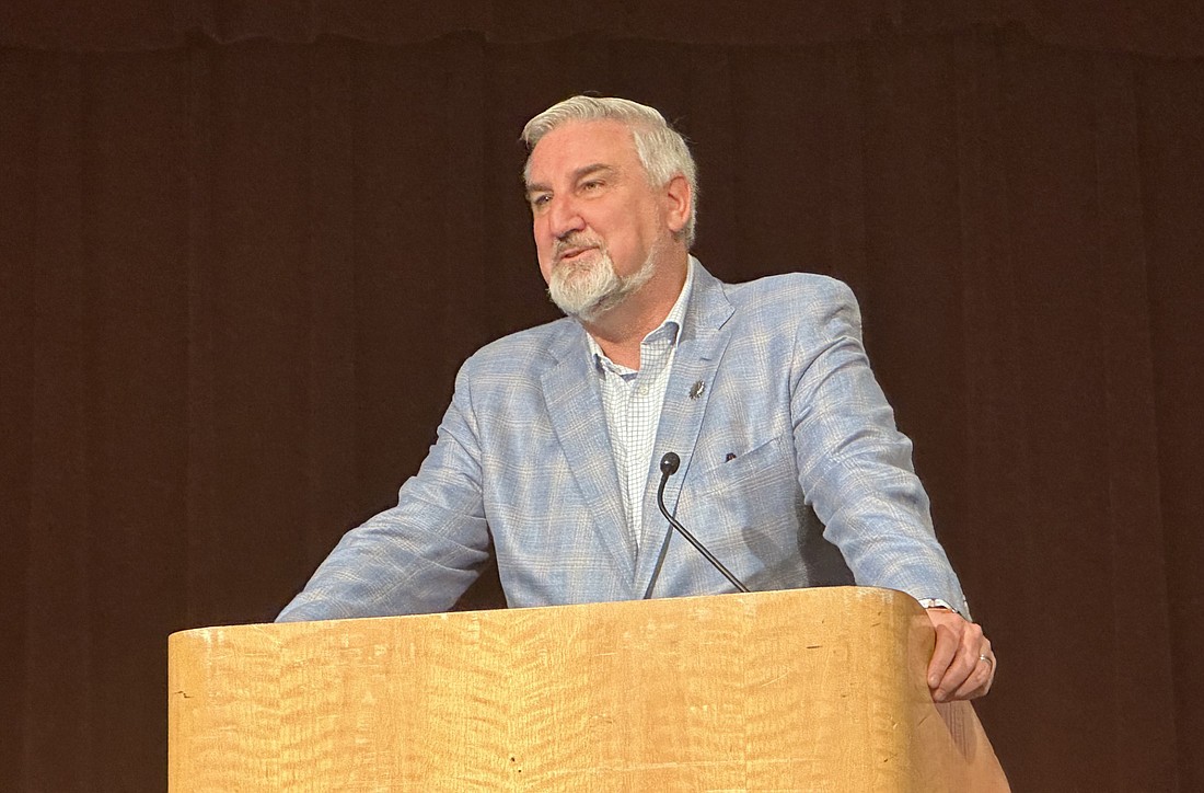 Indiana Gov. Eric Holcomb speaks Thursday about Winona Lake Town Manager Craig Allebach before presenting him with the Sagamore of the Wabash. Photo by David Slone, Times-Union