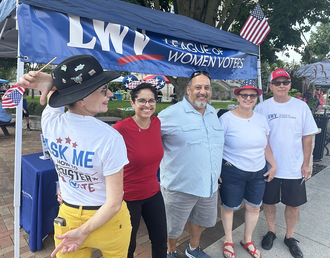 League of Women Voters had a booth at Third Friday downtown Warsaw to register people to vote. Pictured (L to R) are Shari Benyousky, Marlene Betances, Tony Garza, Carol Lewis and John Warren. The back of the shirt Benyousky is wearing says, “Ask me how to register to vote.” Photo by David Slone, Times-Union