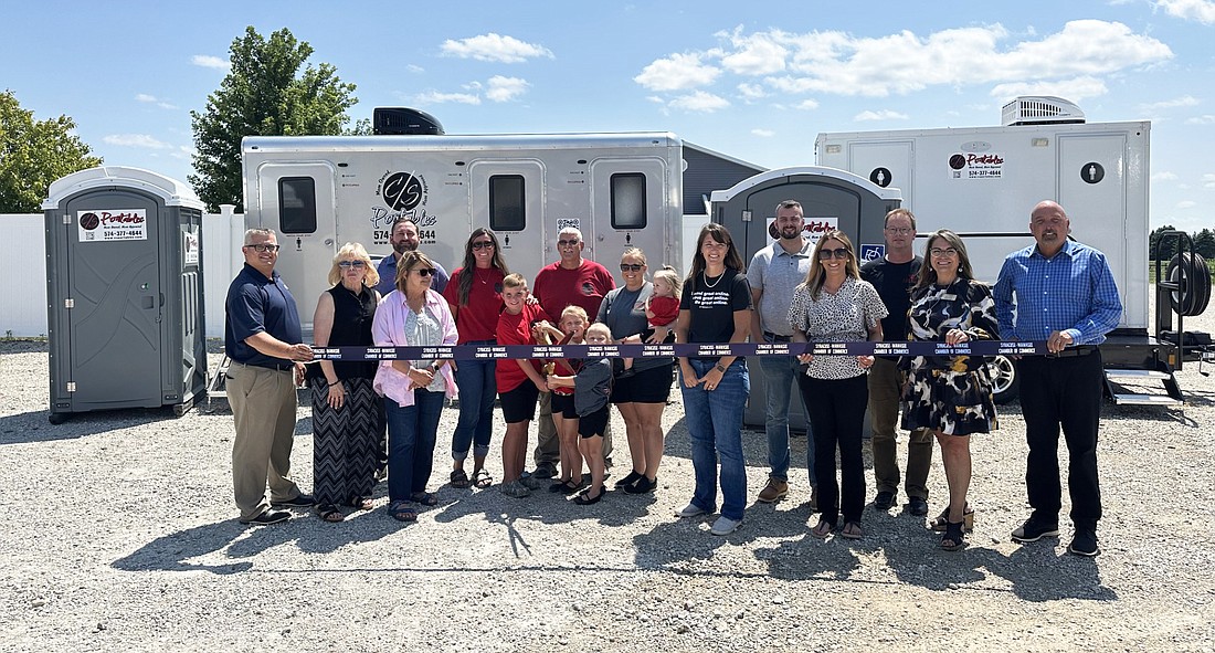 C/S Portables had a ribbon-cutting ceremony Thursday with the Kosciusko Chamber of Commerce and the Syracuse-Wawasee Chamber of Commerce. The Warsaw business is co-owned by Marketing Manager Jess Conley (fifth from left) and Office Manager Stephanie Spangle (10th from left). Kent Coble (C) is the operations manager. Photo by David Slone, Times-Union