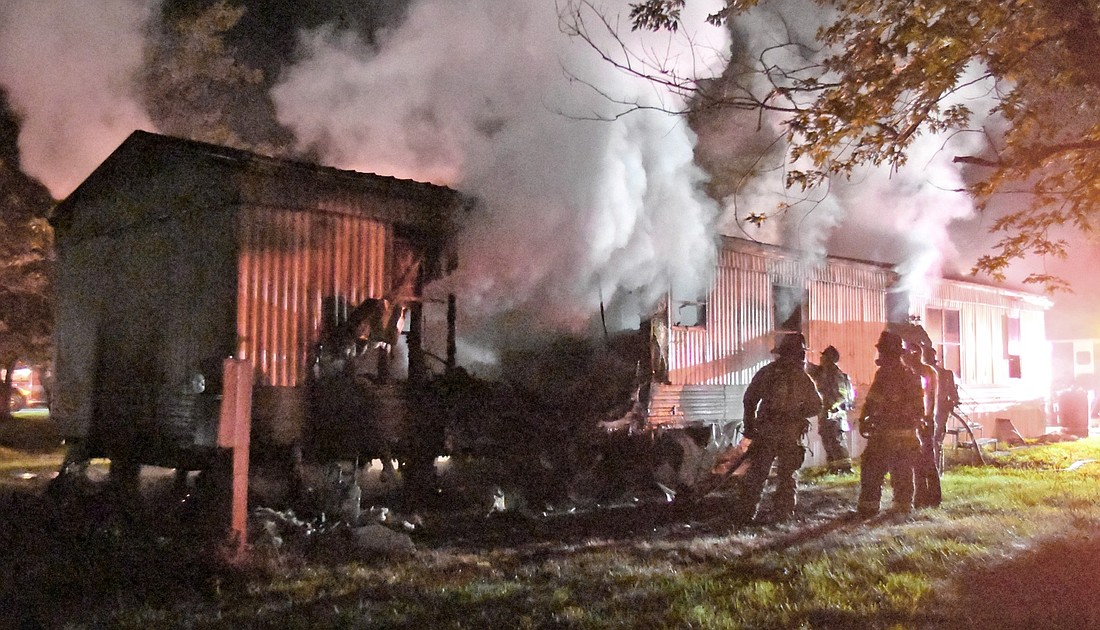 Firefighters were able to quickly knock down the overnight mobile home fire at Hideaway Hills. Photo by Gary Nieter, Times-Union.