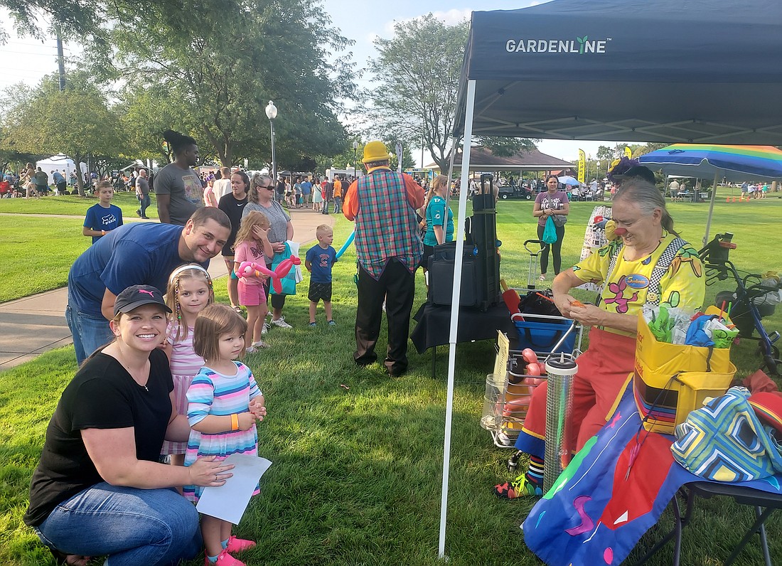 Montana, Eleanor, Helena and Adam Gardner wait for baloon animals made by Sunbeam the clown. Photo by Jackie Gorski, Times-Union