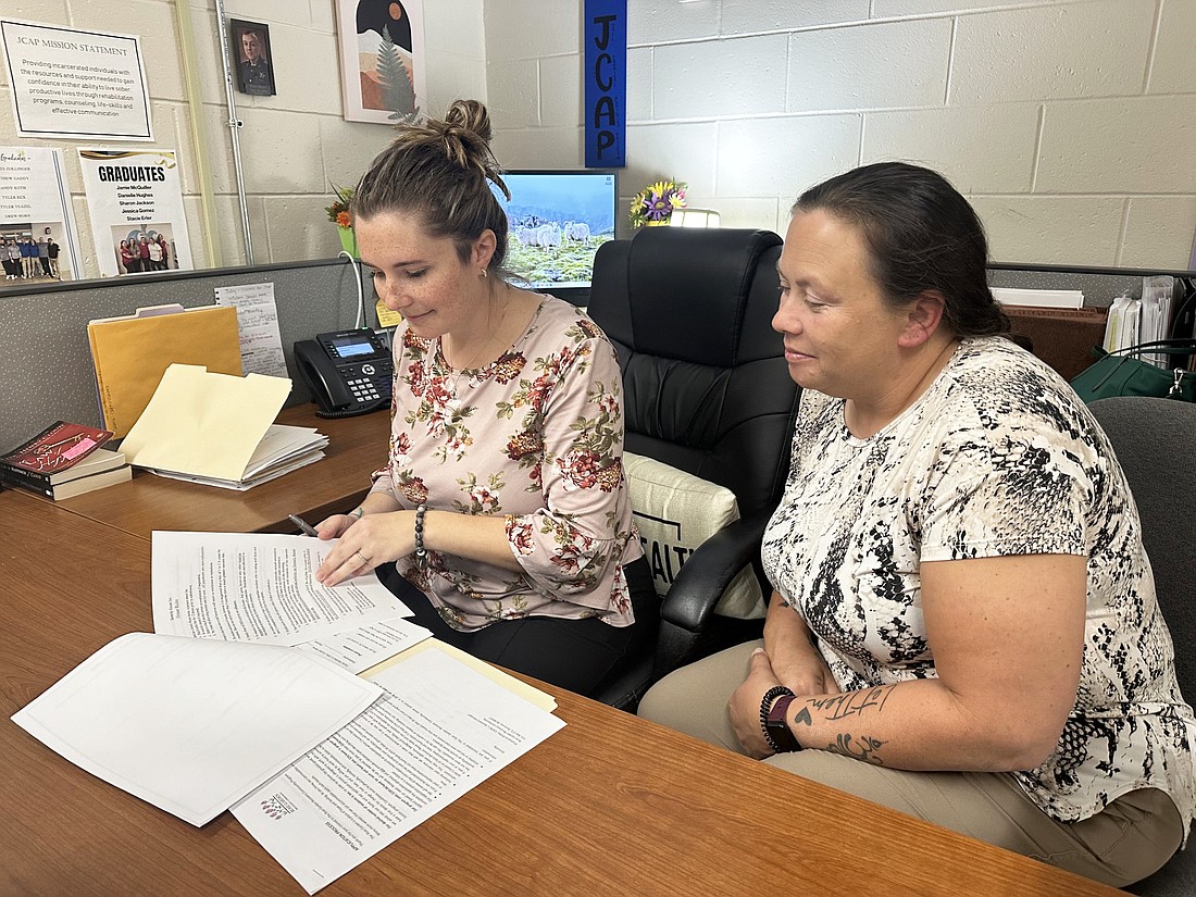 Kosciusko County Recovery Program Recovery Navigator Shanna Wallen (R) and Jail Chemical Addiction Program Coordinator Casey Trombley (L) look over some paperwork at the Kosciusko County Sheriff’s Office on Monday. Photo by David Slone, Times-Union