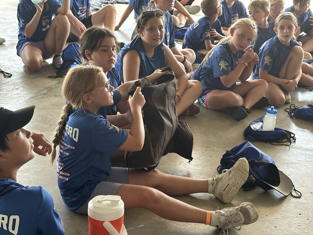 Campers got to check out a Kosciusko County Sheriff’s Office jailer’s real bulletproof vest Tuesday during Camp HERO. Photo by David Slone, Times-Union