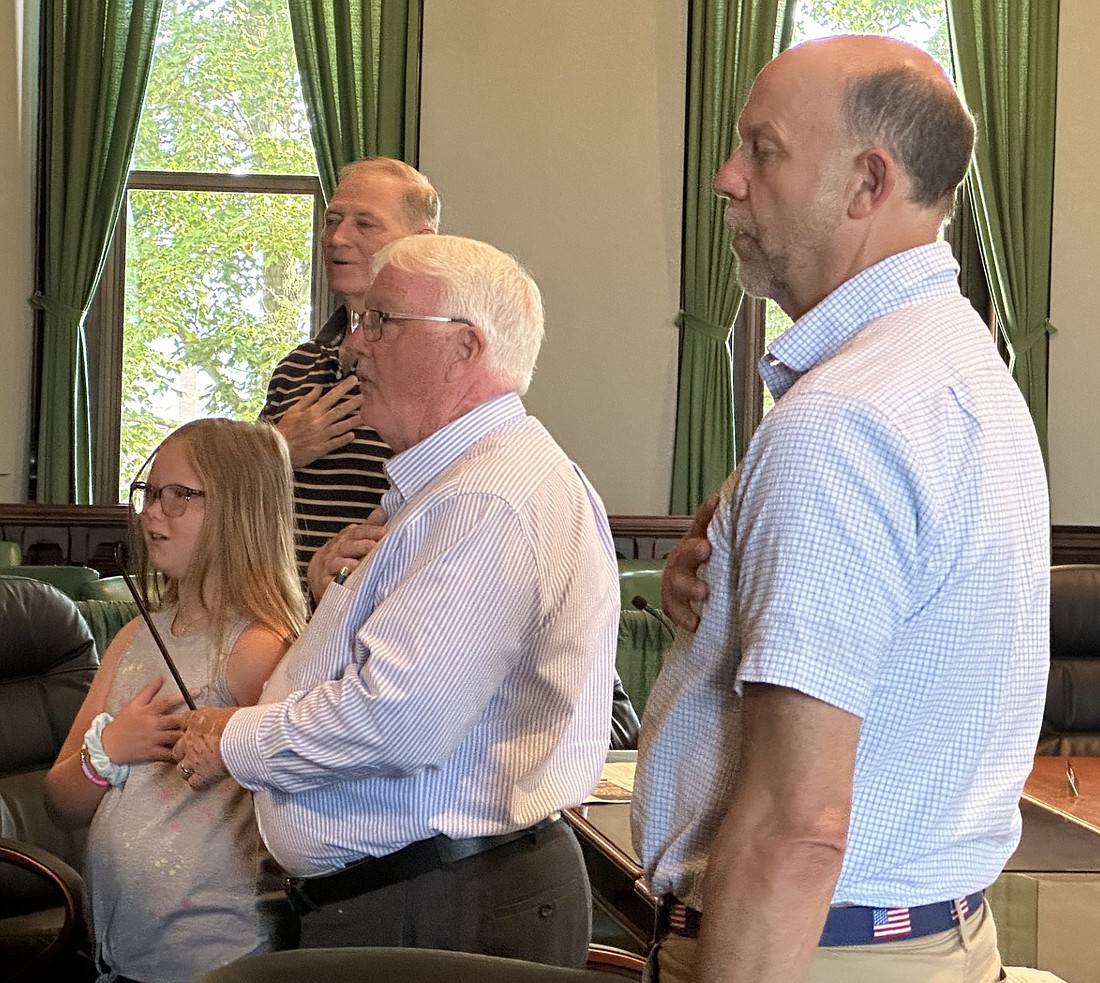 Leesburg Elementary School fourth-grader Ella Conley (L) leads Kosciusko County Commissioners Brad Jackson, Bob Conley and Cary Groninger in the pledge of allegiance Tuesday morning. Ella is the granddaughter of Bob. Photo by David Slone, Times-Union