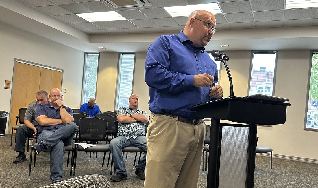 With Warsaw Police Department Chief Scott Whitaker (L) and Capt. Joel Beam sitting behind him, city engineer Aaron Ott explains to the Board of Public Works and Safety why they want to go with the higher of two bids for the WPD security and surveillance camera system. Photo by David Slone, Times-Union