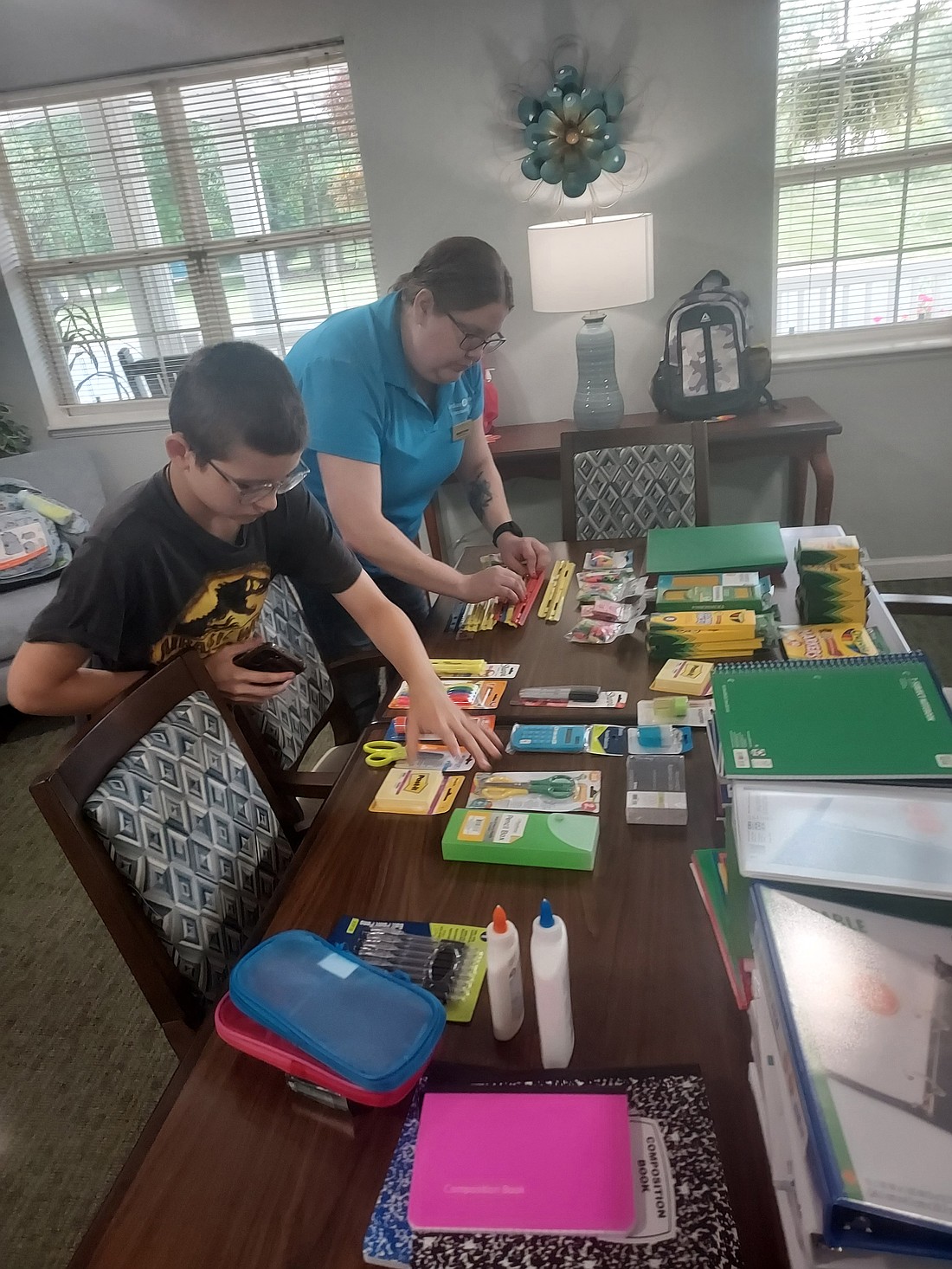 Marcie Fisher, executive director of Cedar Creek of Warsaw, and Chase Jude sort school supplies Friday. Photo by Jackie Gorski, Times-Union