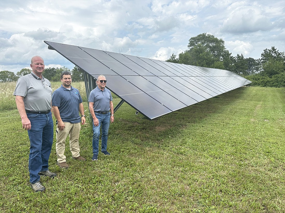 Pictured (L to R) are John Moorman, general manager, Advanced Solar; Glen Miller, owner, Advanced Solar; and Kurt Carlson standing next to the solar panels on Carlson’s Claypool property. Photo by David Slone, Times-Union