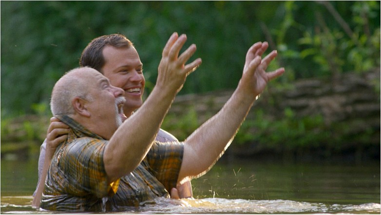 Two characters participate in a baptism in “A Carpenter’s Prayer.” Photo Provided.