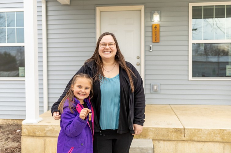 Courtney and Chloe hold the keys to their new Habitat home. Photo Provided.