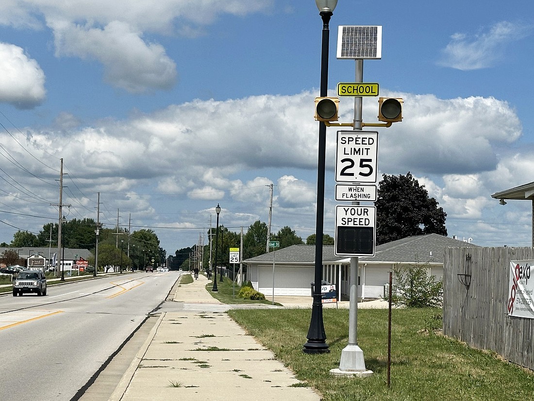 Signs on Husky Trail in Warsaw remind drivers that the speed limit is 25 mph when school is in session and lights are flashing. Otherwise, the speed limit is 35 mph. Photo by David Slone, Times-Union