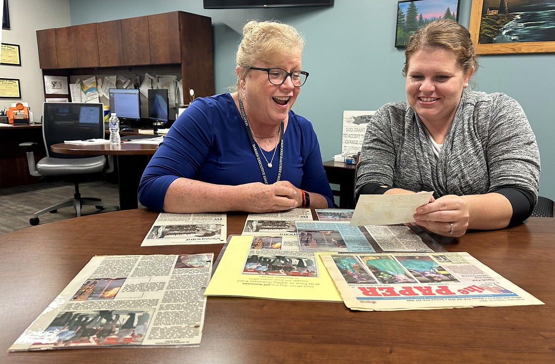 Edgewood Middle School Principal JoElla Hauselman (L) and Warsaw-Wayne Fire Territory Chief’s Assistant Heather Vogts (R) look over laminated articles from Family Safety Day’s first three years - 2004 to 2006. Photo by David Slone, Times-Union