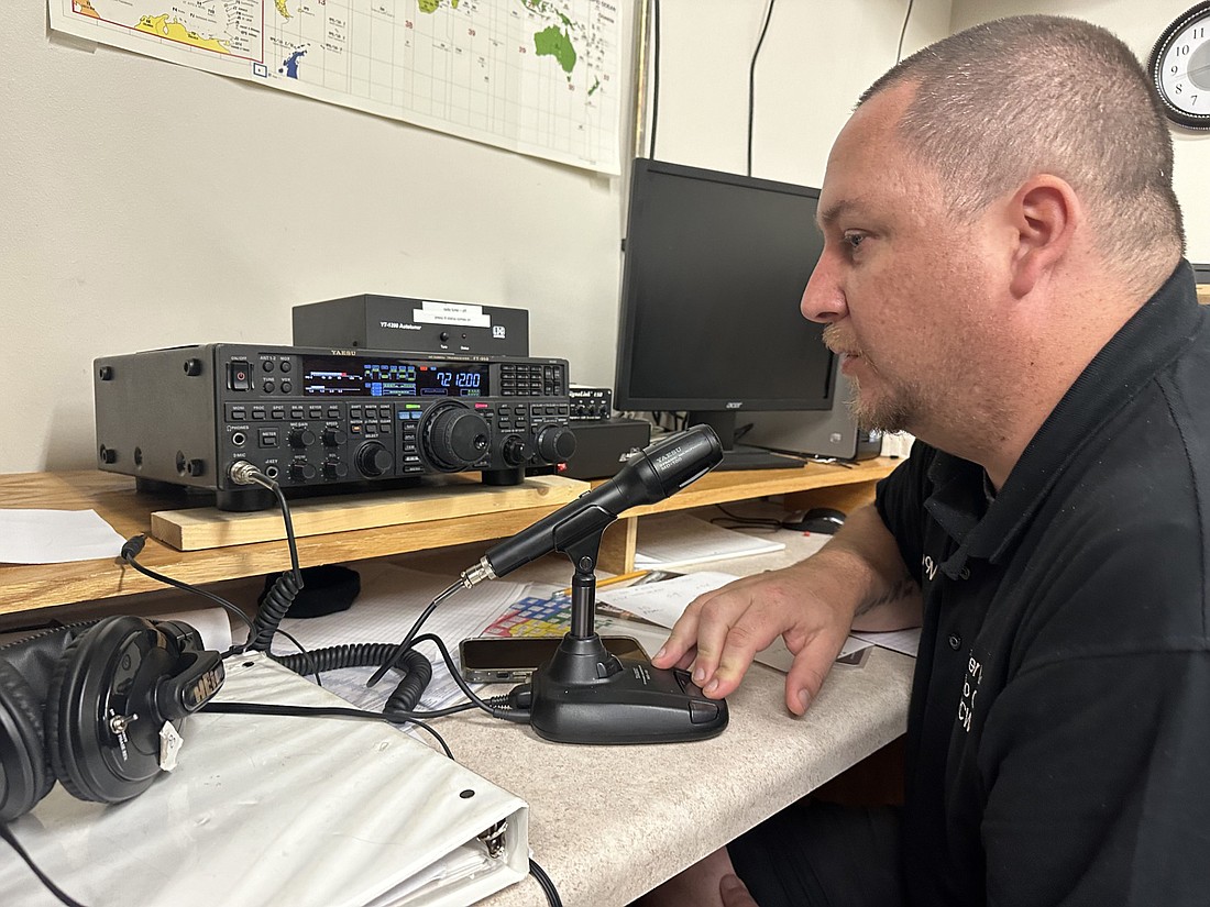 Matthew Carter, public information officer for the Amateur Radio Emergency Services attached to the Hoosier Lakes Radio Club, talks with another person Friday afternoon over the radio in the basement of the Kosciusko County Justice Building. Photo by David Slone, Times-Union