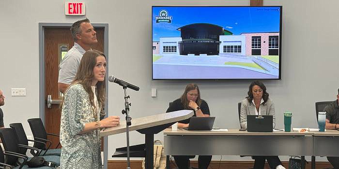 Hannah Holtzapple and Brian Wolf, of Garmann Miller, brought multiple updated renderings of the performing arts center to the Wawasee School Board Monday. The PAC is scheduled for completion in August 2026. Photo by Marissa Sweatland, InkFreeNews