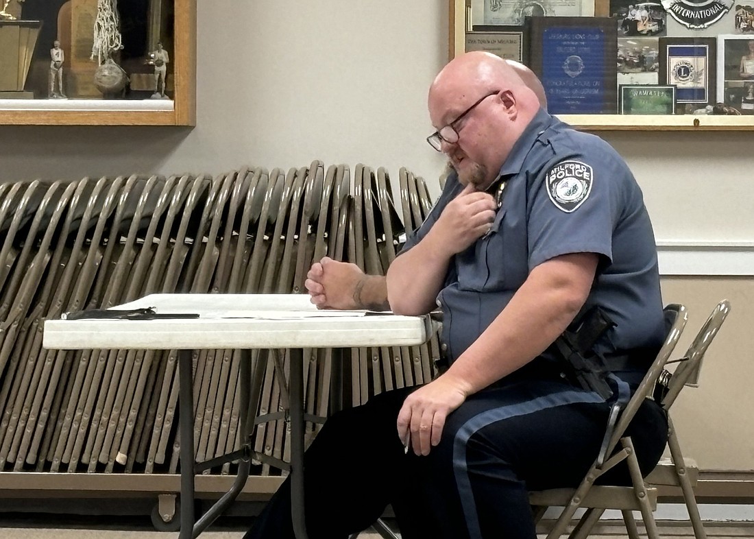 Milford Town Marshal Derek Kreider reads his resignation announcement at Milford’s Town Council meeting Monday evening. Photo by Denise Fedorow