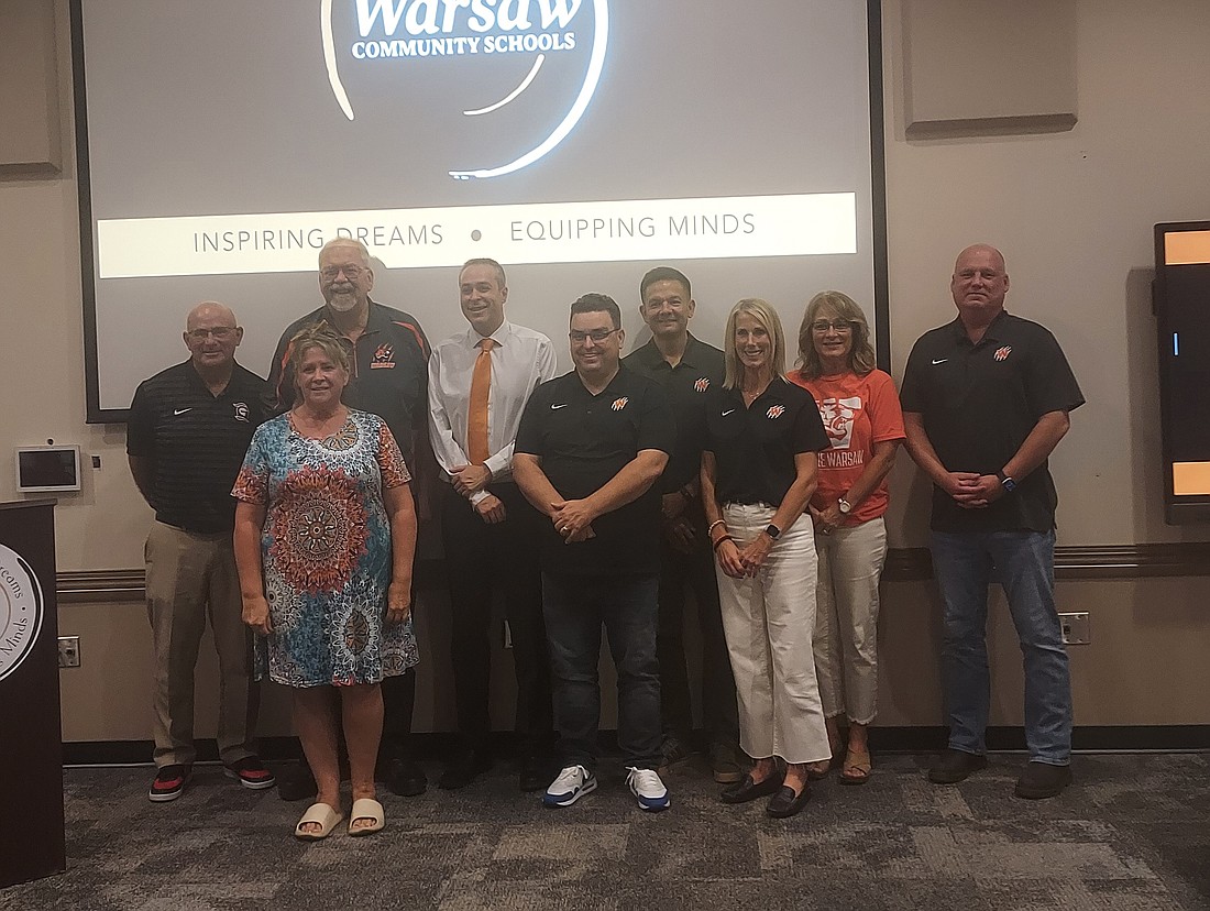 Pictured are Ami Pitt, Project Independence and Hand-Up case manager with Combined Community Services, with Warsaw Community Schools Superintendent Dr. David Hoffert and the Warsaw School Board. Photo by Jackie Gorski, Times-Union