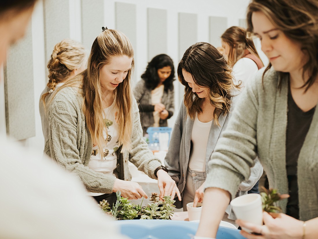 Women cultivate their planting skills at a Lilly Center gardening workshop. 
Photo Provided.