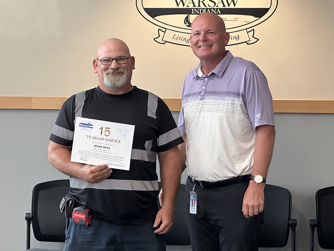 Jesse Hite (L) was recognized Friday at the Warsaw Board of Public Works and Safety meeting for his 15 years with the Warsaw Public Works Department. He is pictured with Warsaw Mayor Jeff Grose (R). Photo by David Slone, Times-Union