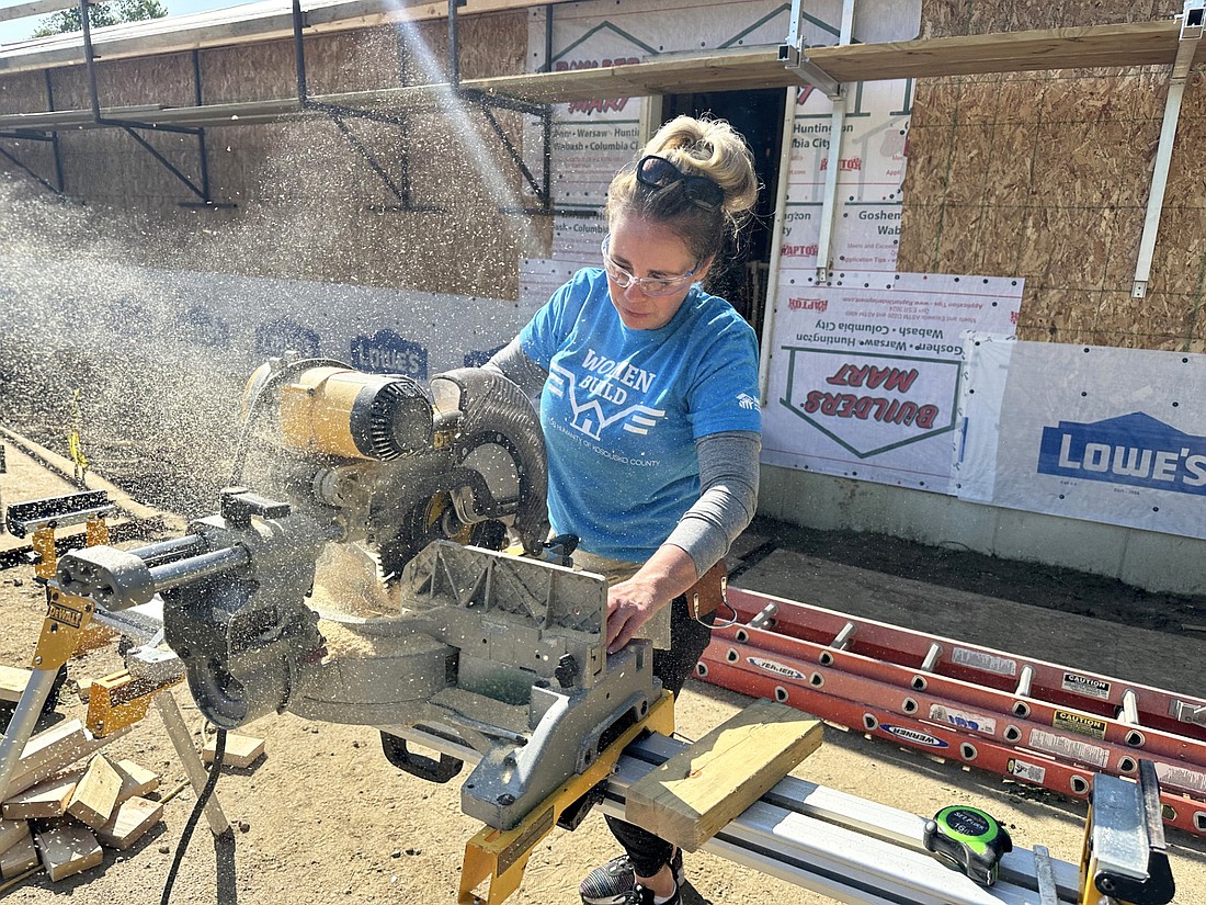 Jody Meyer, Lake City Bank, saws some wood Tuesday during the Habitat for Humanity of Kosciusko County Women Build in Mentone. Photo by David Slone, Times-Union