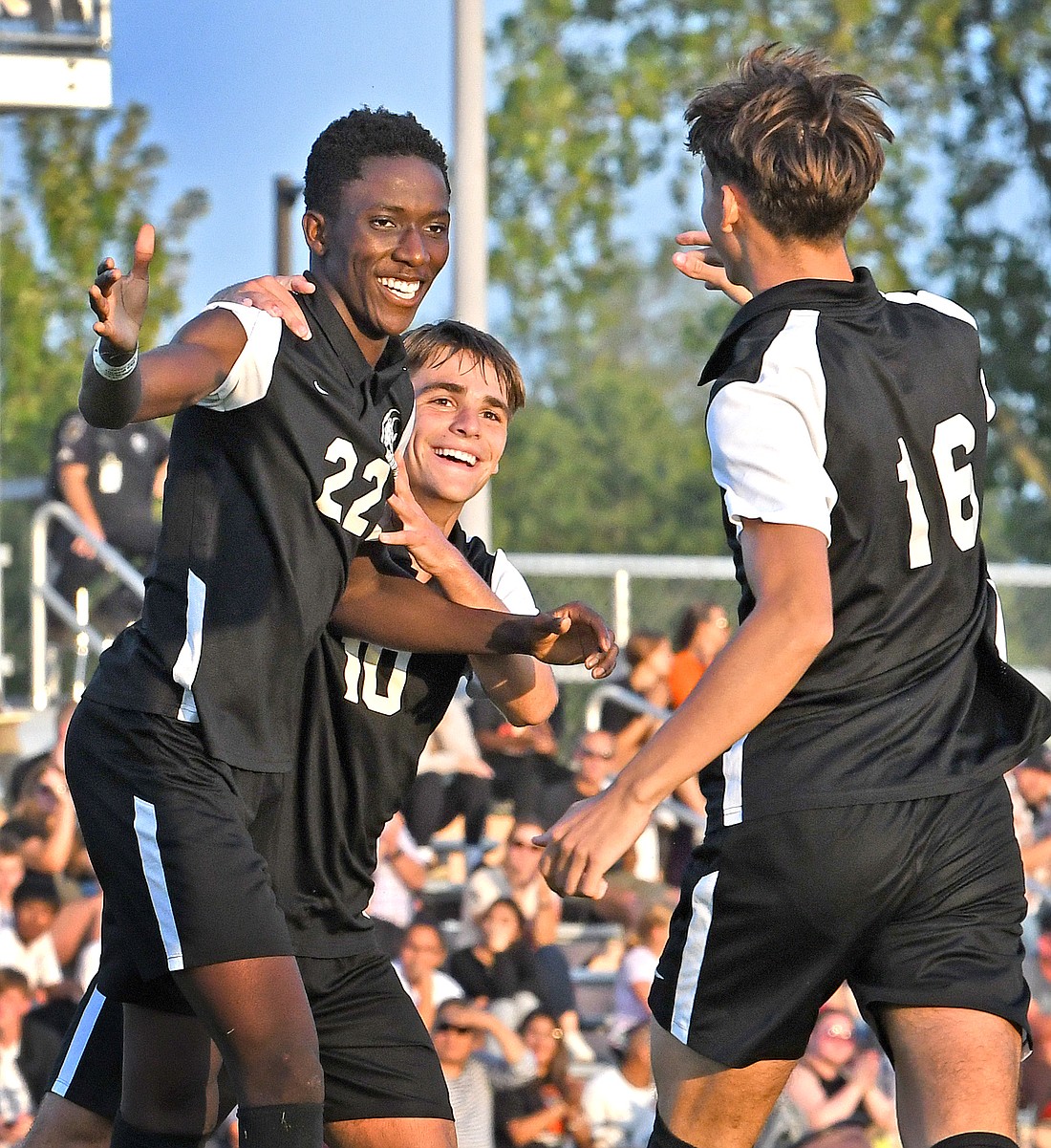 Warsaw junior Mydin Burgher (L) is congratulated for one of his two first half goals by teammates Ashton Ault (back) and Tanner Reynolds...NIeter