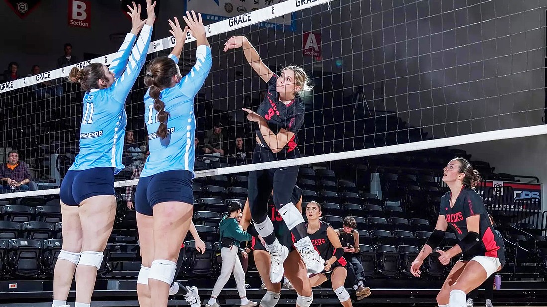 Grace junior Livia Tate goes up for a kill against Spring Arbor.