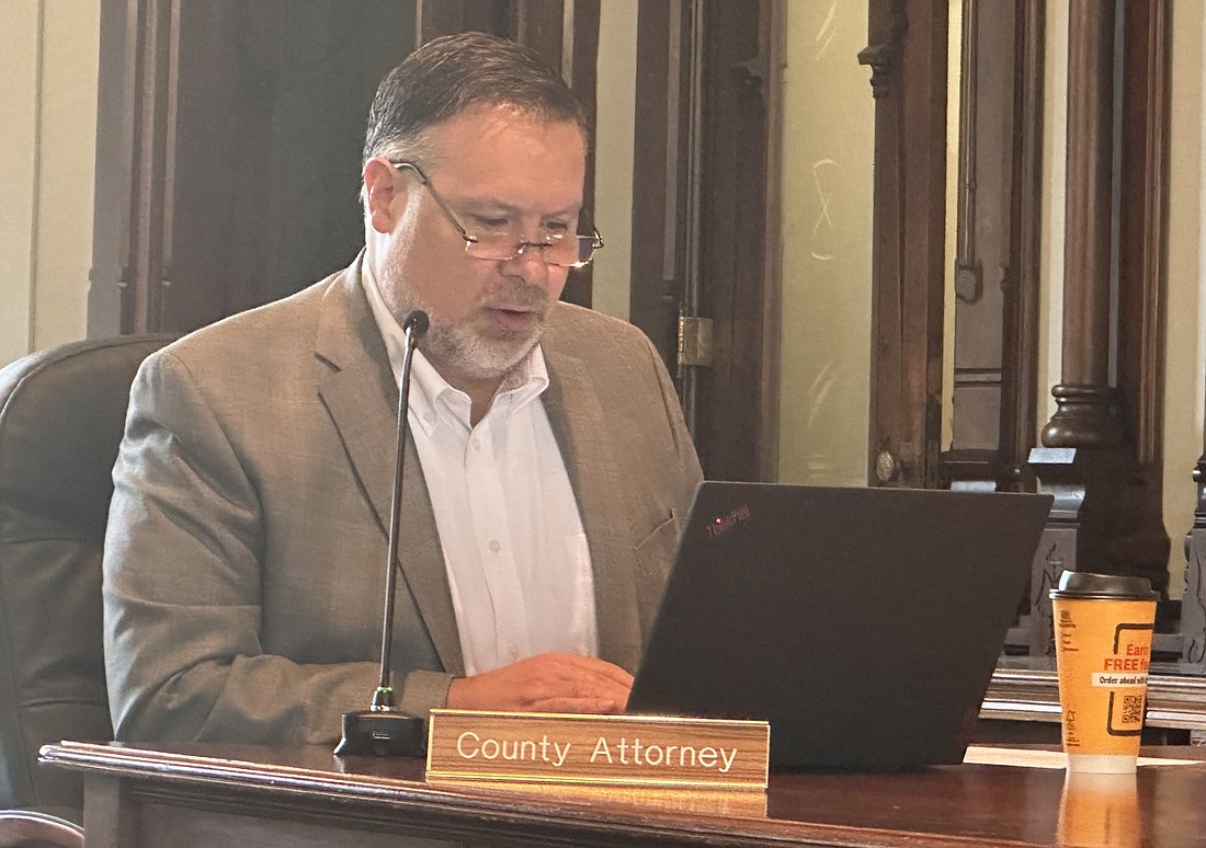 Kosciusko County attorney Ed Ormsby explains the request Tuesday for the commissioners to release county tax liens to the extent allowed by law on the properties at 4881 E. Armstrong Road and 42 EMS T9 Lane, both in Leesburg. Photo by David Slone, Times-Union