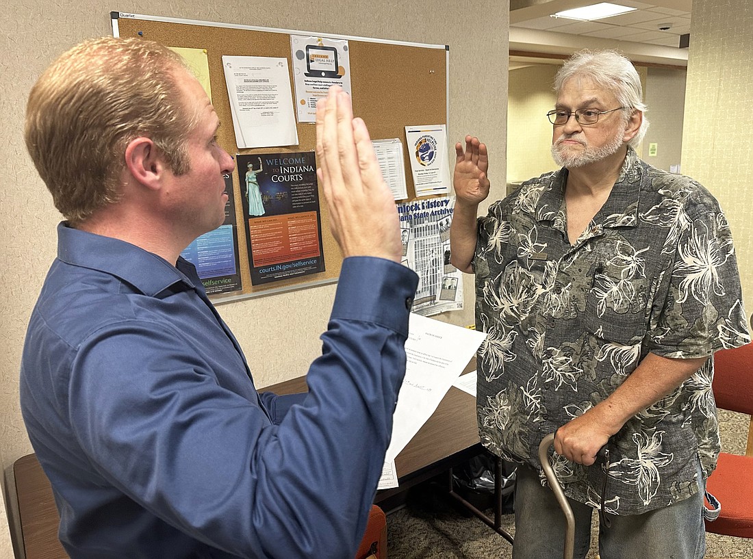 Kosciusko County Republican Party Central Committee Secretary Austin Rovenstine (L) gives the oath of office Tuesday to Keith Claassen (R), who was appointed by Chairman Mike Ragan to the Etna Green Town Board after Jason Hanes resigned. Photo by David Slone, Times-Union