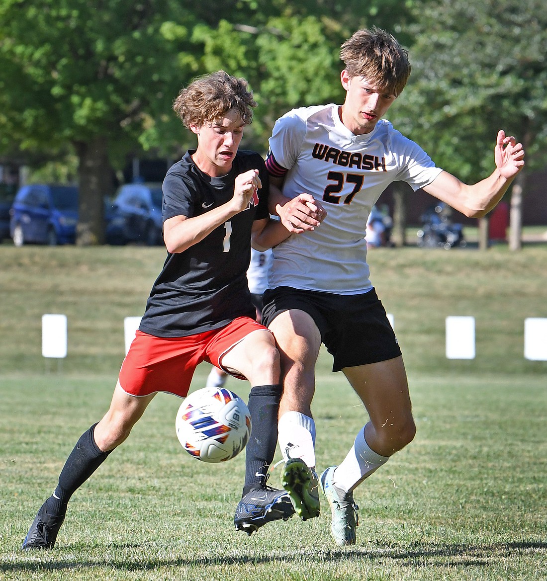 Manchesster freshman Wyatt Schroll (L) and Prestyn Jones of Wabash battle for the ball during the first half...Nieter