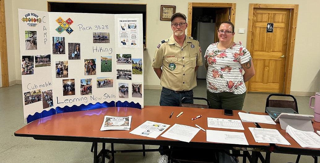 Syracuse Cub Scout leaders Bill Bunch (L) and Leigh Scott (R) present Scouting information to parents during Pack 3828’s annual Scout round-up night. There is still time for boys and girls in kindergarten through fifth grade to join. Photo Provided.