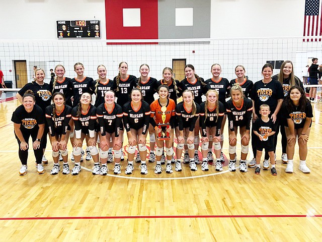 The Warsaw volleyball team celebrates winning its thid straight Plymouth Powerball Tournament.