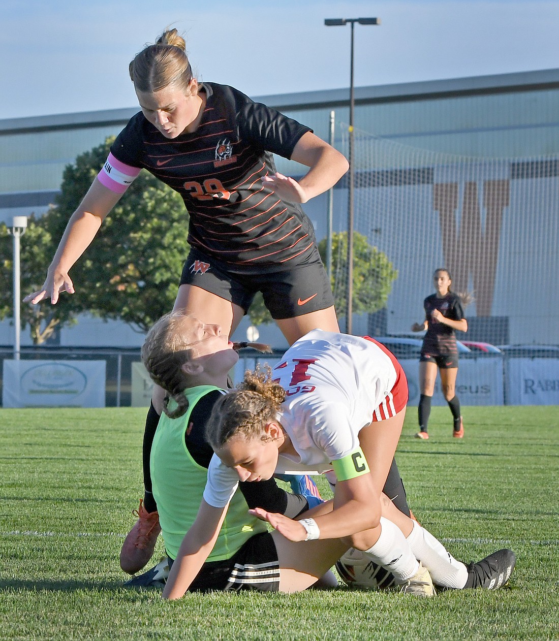 Warsaw junior Lola Pepper (top) collides with Goshen goalie Ava Yordy and Sydney McLaughlin during the first half...Nieter