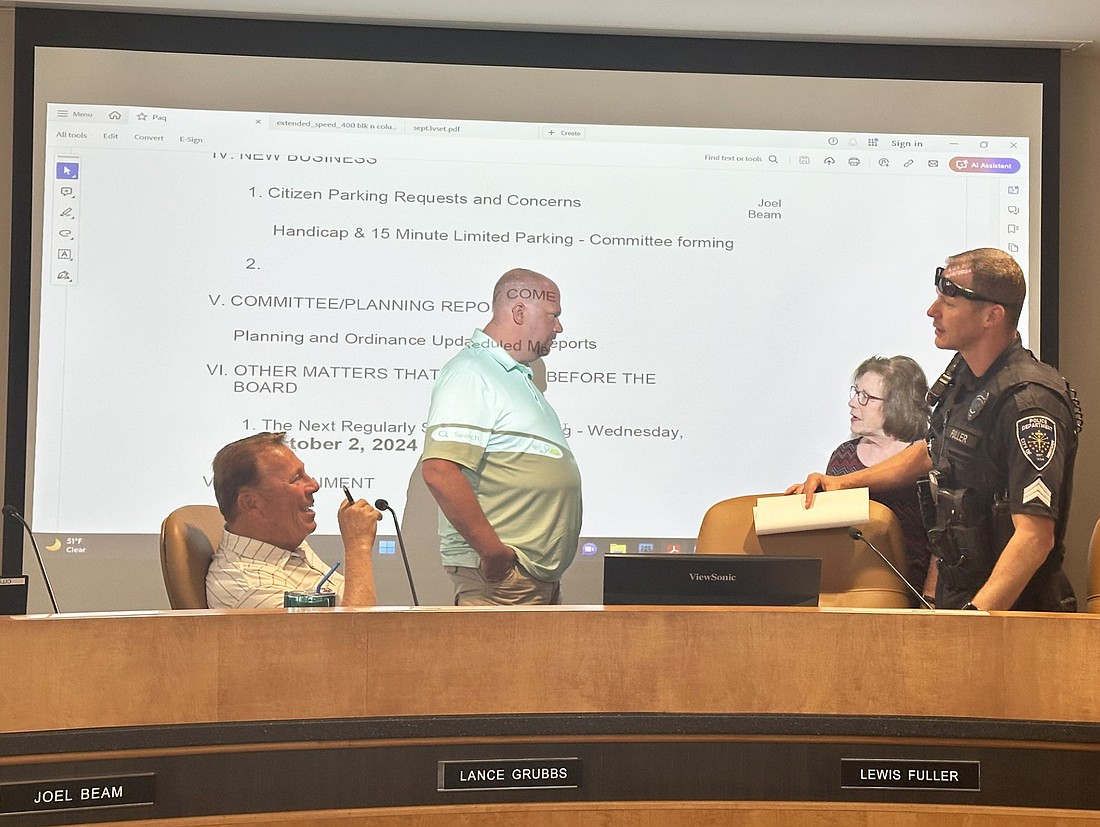 After wrapping up the Warsaw Traffic Commission meeting Wednesday, Traffic Administrator Lance Grubbs (seated, left) speaks with Warsaw Police Department Sgt. Lewis Fuller (standing right), while (in back) WPD Capt. Joel Beam has a conversation with Warsaw Common Councilwoman Cindy Dobbins. Photo by David Slone, Times-Union