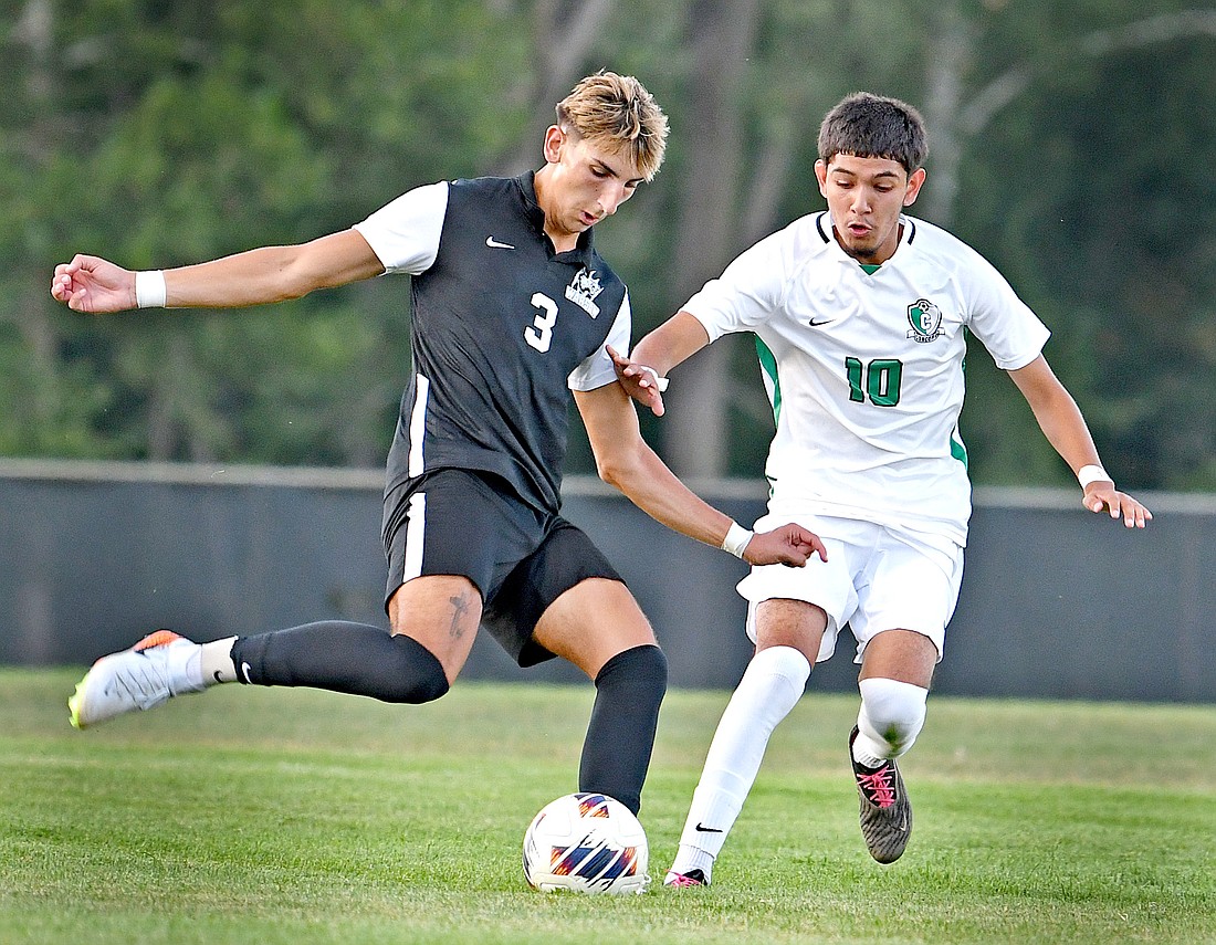 Warsaw senior Luke Barbosa winds up for a kick during the first half as Angel Rodriguez of Concord moves in to defend...Nieter