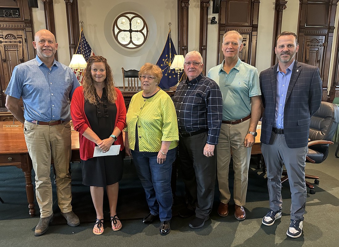 Zak Greer is the latest recipient of the Nationwide Retirement Solutions Scholarship presented in partnership with the Association of Indiana Counties. The announcement was made at the Kosciusko County Commissioners meeting Tuesday. Pictured (L to R) are: Cary Groninger, commissioner, Brooke Greer, Zak’s mother who accepted the scholarship on his behalf; Sue Ann Mitchell, county councilwoman and current first vice president of AIC; Bob Conley and Brad Jackson, county commissioners; and Kevin Mitchell, Nationwide Retirement Solutions state program director. Photo by David Slone, Times-Union