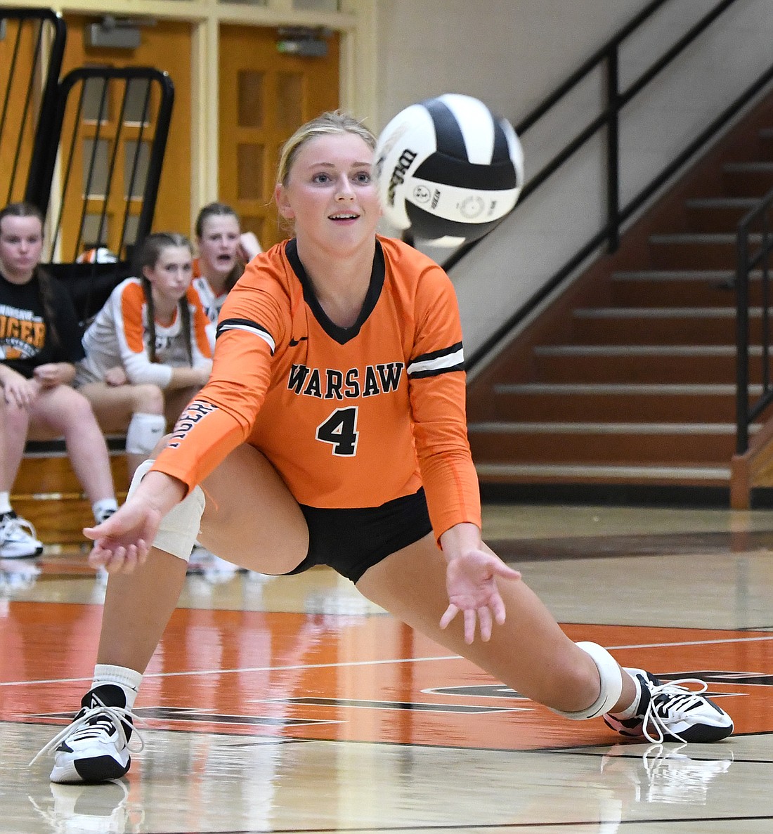 Junior Cecelia Goode of Warsaw goes low for the ball during Tuesday night's home match against Northridge...Nieter