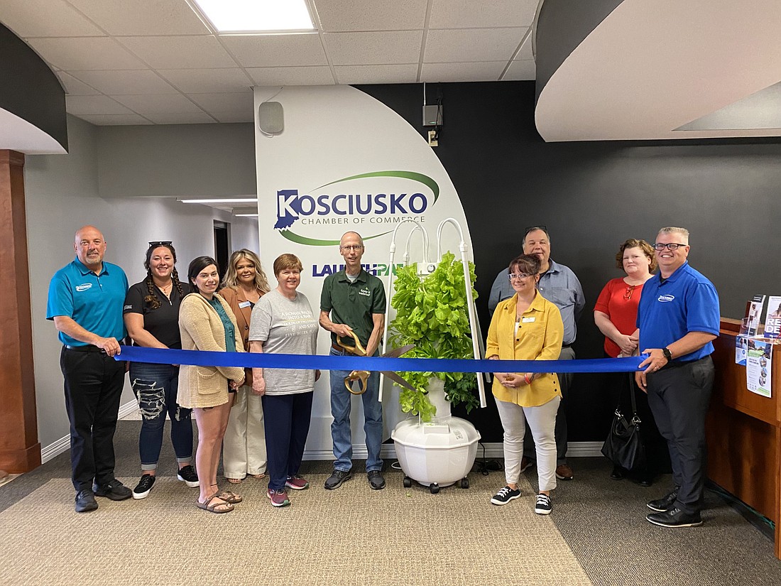 Kosciusko Chamber of Commerce had a ribbon-cutting for Keep It Watered on Wednesday. It offers tower garden systems like the one in the photo whereby plants may grow indoors or out. Pictured (L to R) are Chamber Member Relations Manager Scott Wiley; Chamber ambassadors Kierstyn Jones, Kristi Hull, Stacey Leek and Lynn Brown; Keep It Watered owner Steve Koontz; Chamber ambassadors Melissa Paxton, James Kofalt and Debora Eichman; and Chamber President and CEO Rob Parker. Photo by Leah Sander, InkFreeNews