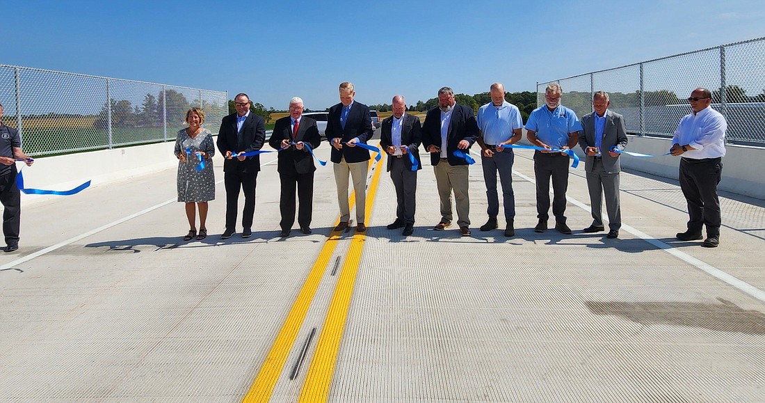 The official opening of the new Bradford L. Jackson Way of Kosciusko County took place at 1 p.m. Thursday. Participating in the official ribbon-cutting were Marsha McSherry, county administrator; Jason Holden, INDOT project manager; Brad Jackson, county commissioner; Mike Smith, INDOT commissioner; Steve Moriarty, county highway superintendent; Cary Groninger, county commissioner; Andy Brown, Phend & Brown; and state Rep. Craig Snow. Photo by Deb Patterson, InkFreeNews