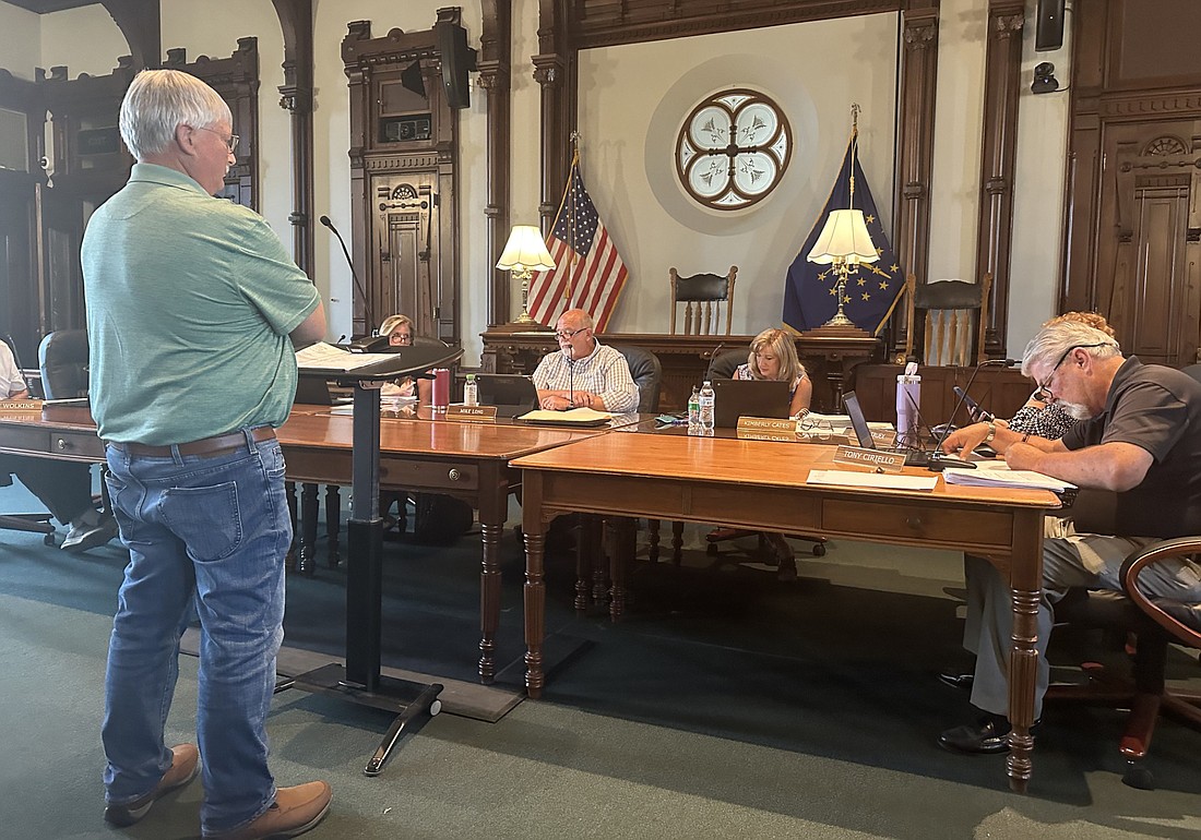 Kosciusko County Surveyor-elect Jim Moyer (standing) listens to the County Council Thursday as they discuss the wages for the surveyor and chief deputy surveyor for 2025. Photo by David Slone, Times-Union