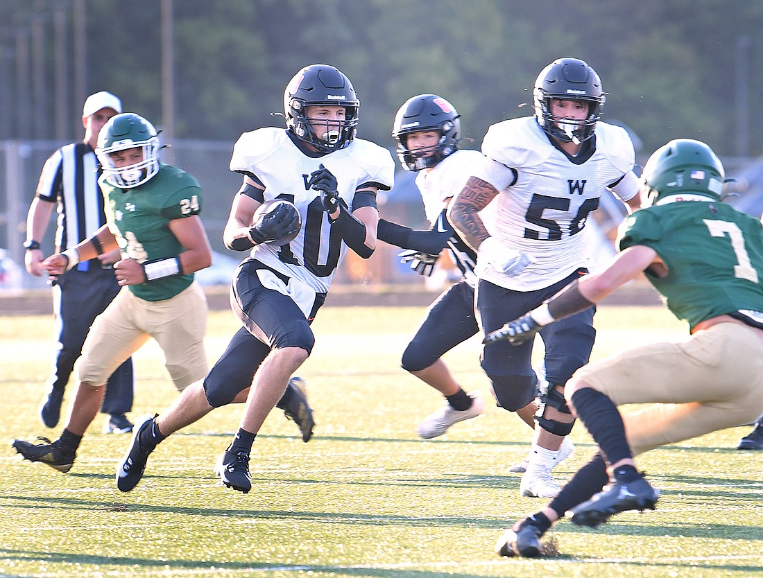 Junior Quinton Brock sets the tone for the night for Warsaw by running for a touchdown on the first play from scrimmage...Nieter