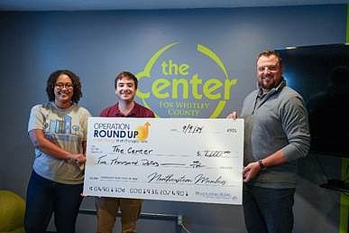 Chris Todd (R), Northeastern REMC, presents a check to The Center for Whitley County Youth. Photo Provided.