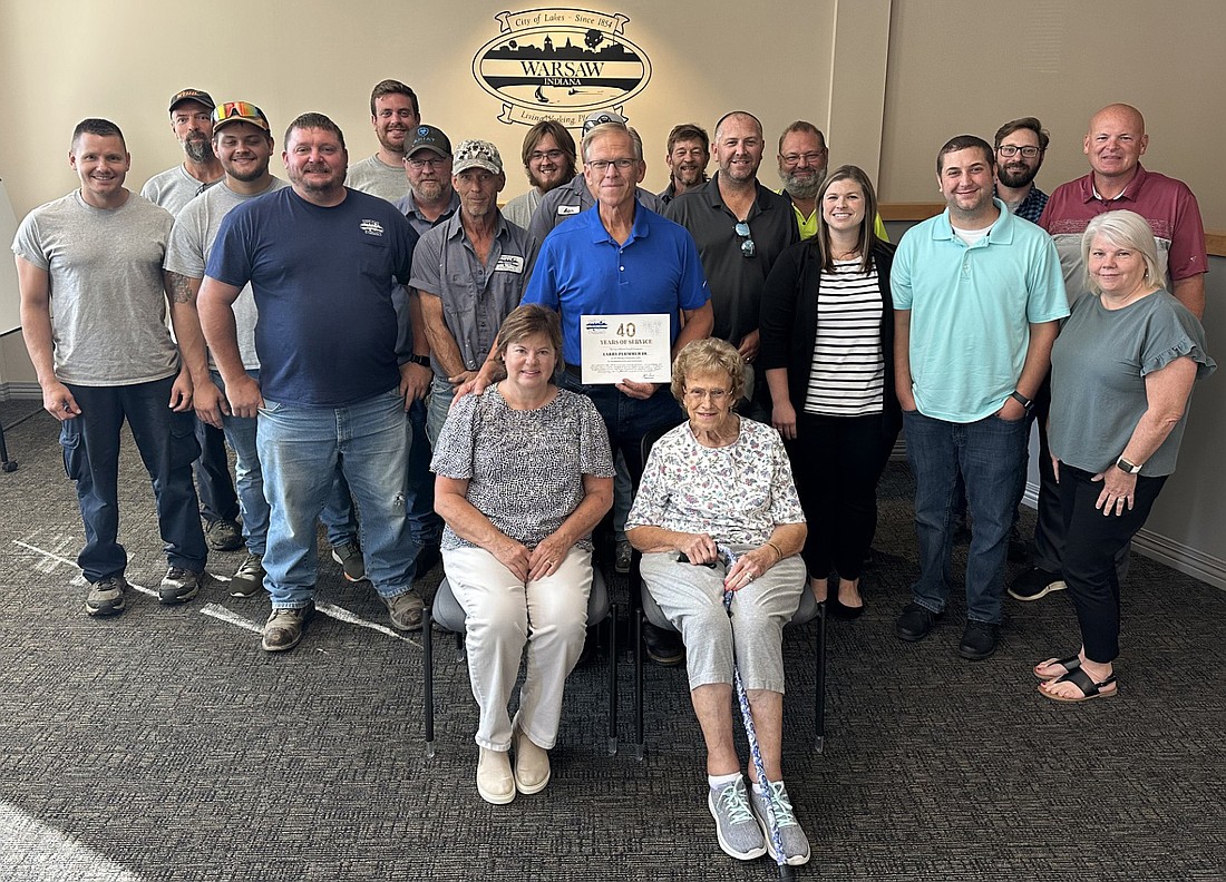 Warsaw Parks and Recreation Department Superintendent Larry Plummer Jr. (front, center) is in his 40th year of working for the city of Warsaw. Pictured with him at Friday’s Board of Public Works and Safety meeting are his staff; wife, Lynn; mother, Dorothy; and Mayor Jeff Grose. Photo by David Slone, Times-Union