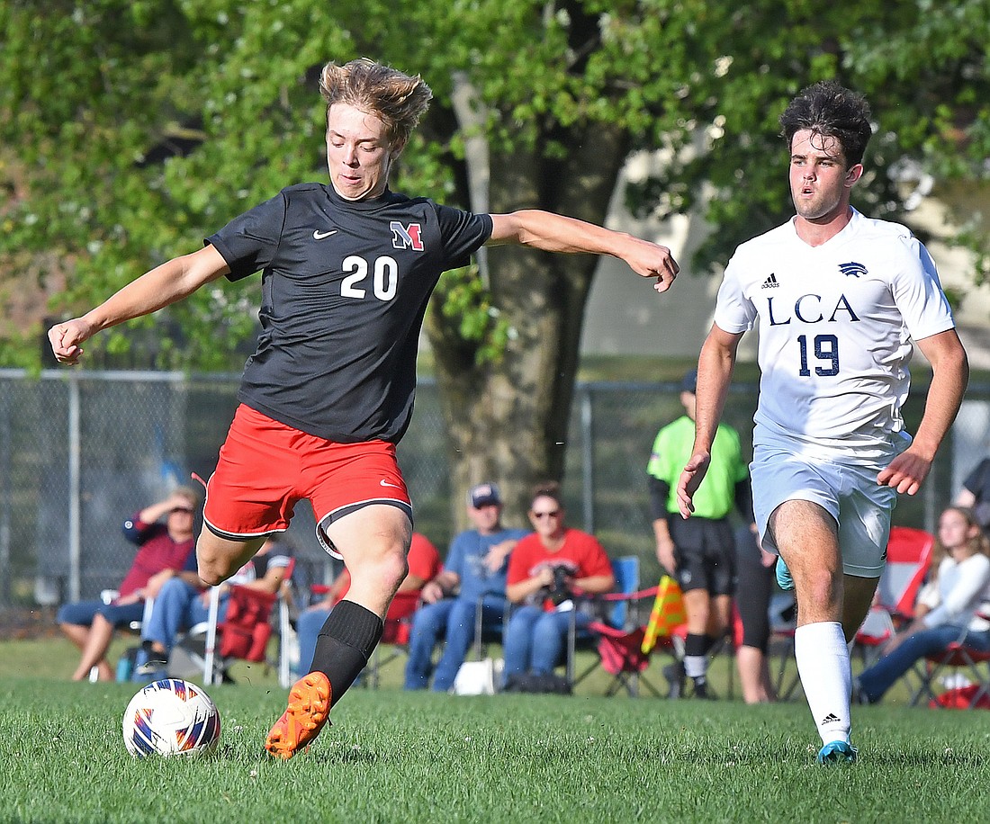 Noah Higham of LCA (R) gives chase as Manchester's Colton Reffitt sends the ball upfield...Nieter