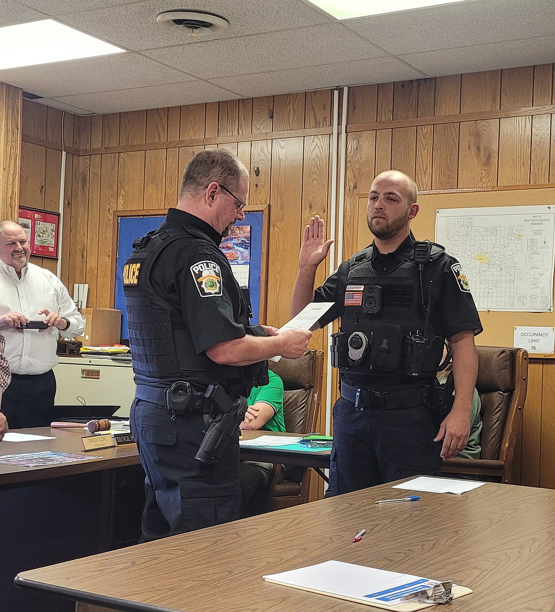 Isaac Haupert (R) is sworn in by South Whitley Town Marshal Mikel Vandevender. Photo by Maddie Jo Shultz