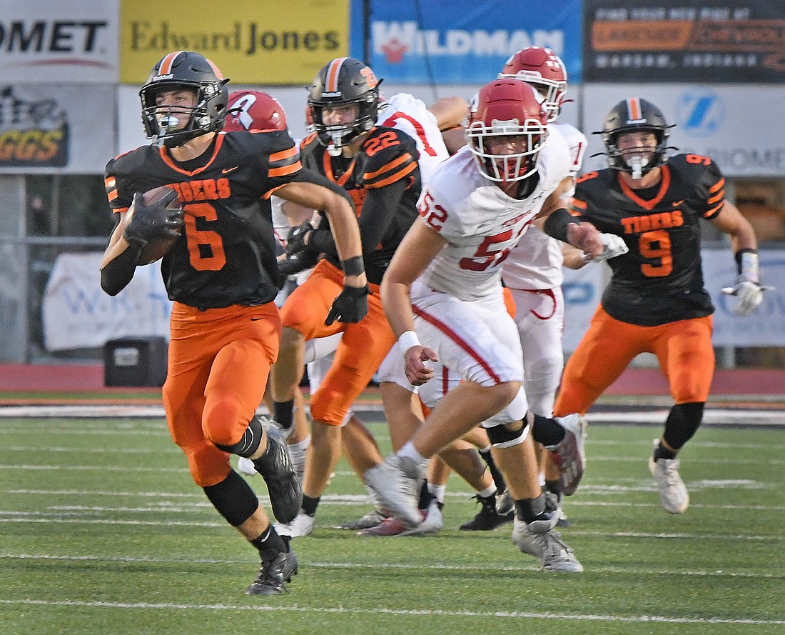 Warsaw senior Tristan Wilson takes off for a long run after a Plymouth kickoff in the first quarter...Nieter